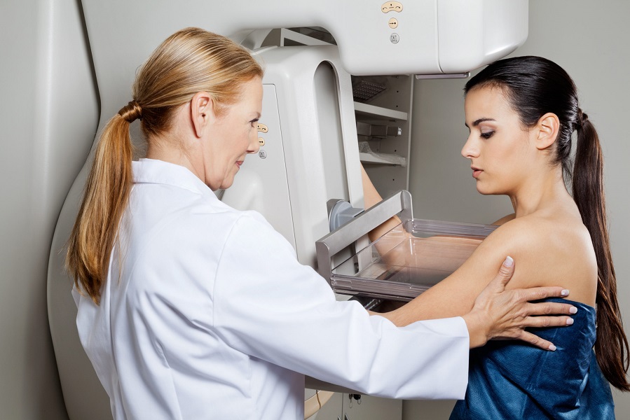 Mature female doctor assisting young patient undergoing mammogram | Kay Dermatology in Burbank, CA
