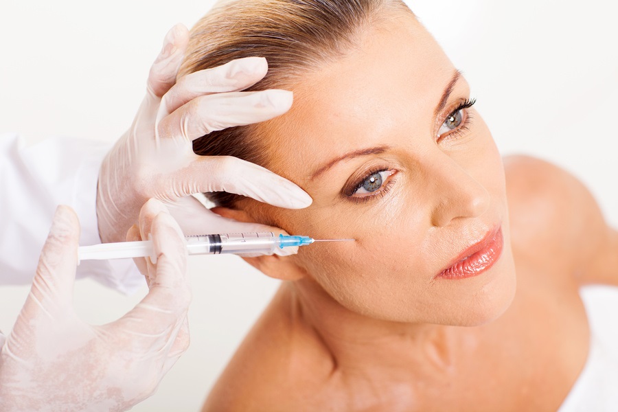 doctor giving mid age woman face lifting injection closeup | Kay Dermatology in Burbank, CA