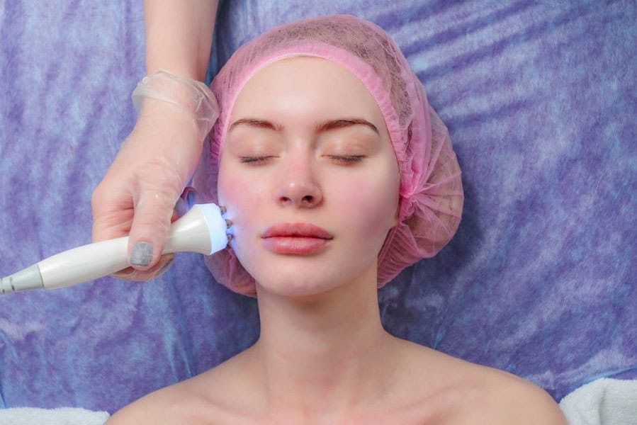 Closeup Woman Getting Facial Hydro Microdermabrasion Peeling Treatment At Cosmetic Beauty Spa Clinic. Face Skin Care. Young woman laying eyes closed, receiving facial beauty treatment in beauty salon | Kay Dermatology in Burbank, CA